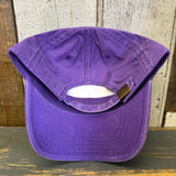 Purple cotton dad hat featuring a lifeguard tower, shown upside down on a rustic wooden surface.
