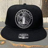 Black 6-panel snapback hat with a California surf patch; suitable for casual, everyday wear.
