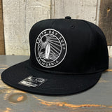 Black snapback hat with surfboard and wave patch, suitable for casual wear. Made of fabric, adjustable fit.
