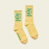 Yellow crew socks with green text, a cowboy graphic, and vintage-inspired design. Suitable for casual wear.