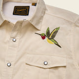 Beige shirt with embroidered hummingbird design and Howler brand label.