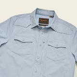 Sky blue long-sleeve tech shirt with two chest pockets and UPF 35 protection, designed for outdoor wear.
