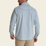 Man wearing a blue long-sleeve performance shirt with UPF 35 protection, shown from the back.