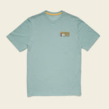 Light blue t-shirt with a logo on the chest against a beige background.