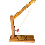 Mini tabletop basketball game with wooden base, metal swing hoop, clear backboard, and attached ball for desktop play.