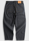 Dark wash striped denim pants with roomy fit, rear pockets, and tan leather patch on the waistband, shown from the back.