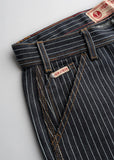 Dark wash striped denim pants with brown stitching and relaxed fit; durable material suitable for everyday wear.