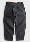 Dark wash striped denim pants with brown stitching, angled pockets, and sturdy construction, laid flat for display.