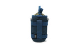 Blue recycled-fabric tube caddy with straps, drawstring closure, and a green bottle for organized carrying.