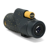 Black and yellow monocular with NOCS branding on a white background