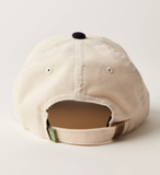 Beige cap with a black brim on a light gray background
