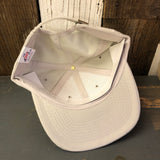 Inside-out black denim 6-panel cap on wood, displaying interior stitching and fabric tag.