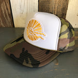 Camouflage trucker hat with white front panel and sunburst hb logo, featuring mesh back for breathable casual wear.