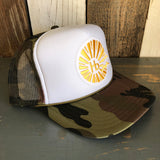 Camouflage trucker hat with white front, sunburst logo, and mesh snapback; casual and breathable headwear.