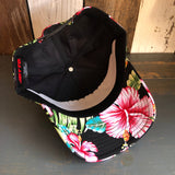 Pink hibiscus-patterned 6-panel cap with visible interior lining, shown from an overhead angle.