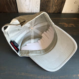 Khaki 6-panel low profile dad hat, shown inside out with a white plastic insert in the front crown for structure.