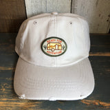 Stone cotton dad hat featuring a camper and cacti patch on the front, ideal for casual outdoor wear.