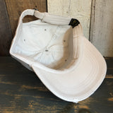 Inside-out stone-colored dad hat made of cotton rests on rustic wooden panels.