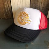 Trucker hat with gold sunburst logo, red mesh back, black bill, and adjustable snapback closure.