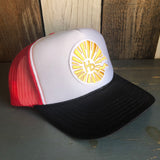 Black, white, and red trucker hat with mesh back and sun emblem design; ideal for casual outdoor wear.
