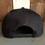 Black 5-panel snapback hat shown from the back with an adjustable strap, made of durable fabric.