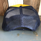 Navy and gold trucker hat with adjustable snapback and mesh panels for breathable, comfortable wear.