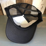 Upside-down trucker hat with mesh back and plastic snap closure, showing detail of material and construction.