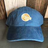 Blue cotton baseball cap with yellow sun patch and HB initials on wooden background