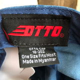 Close-up of OTTO Cap label on blue hat, with one size fits most text visible